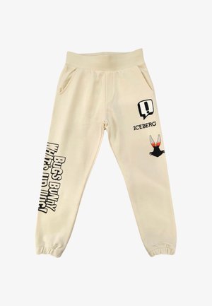 Pantaloni della tuta beige con polsini elastici, tasche frontali, scritta "Bugs Bunny What's Up Doc?" sulla gamba sinistra e logo Iceberg con orecchie da coniglio sulla coscia destra.