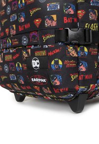 Black backpack featuring various DC Comics character designs and logos. Durable fabric, sturdy hardware, and a wheeled base for mobility.