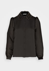 Svart blus med knappstängning framtill och långa genomskinliga ärmar. Har en texturerad krage prydd med guldfärgade nitar. Slätt tyg.