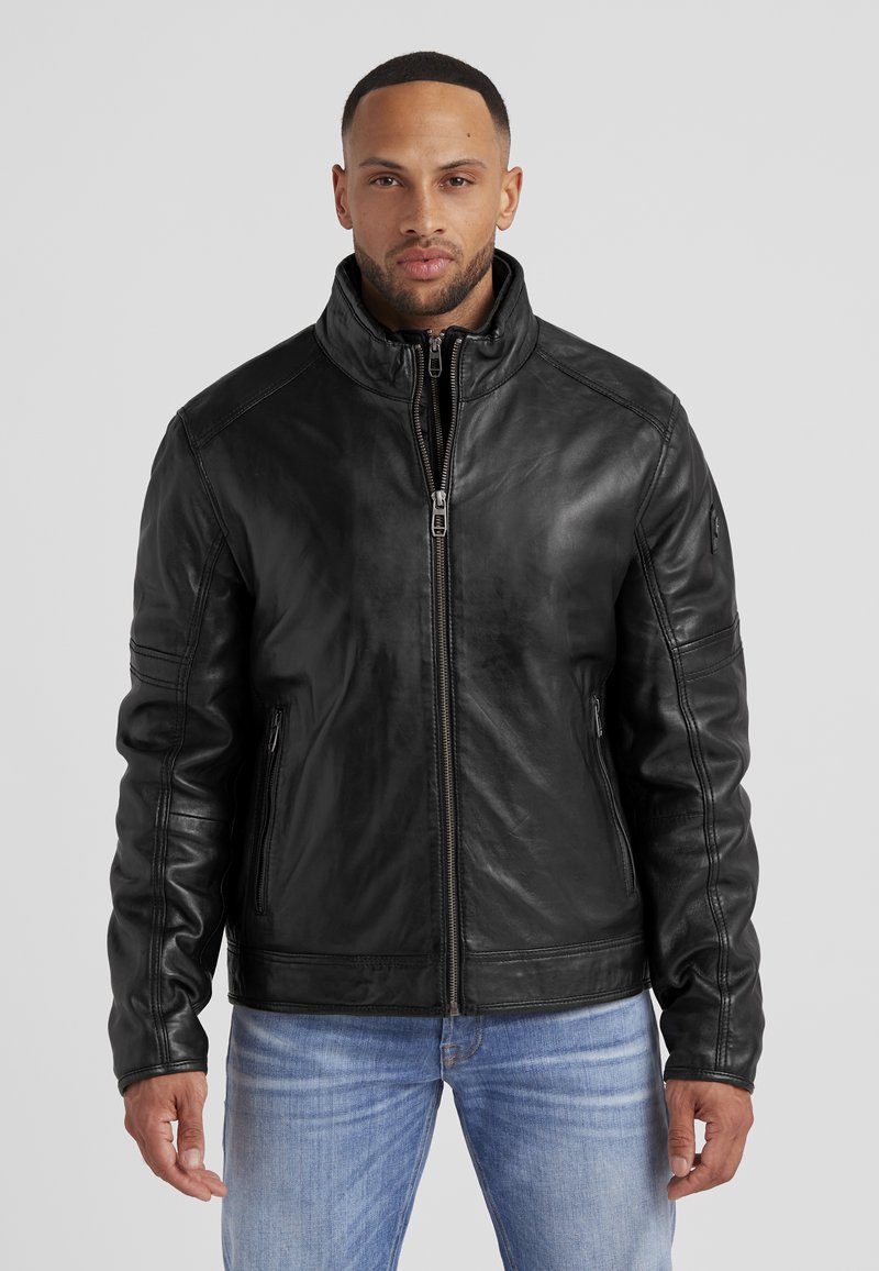 Schwarze Lederjacke mit hohem Kragen und einem Frontreißverschluss, ausgestattet mit Seitentaschen und genähten Details an den Ärmeln.