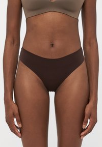 Brown cotton blend bikini underwear with a smooth texture, low-rise design, and a seamless finish, featuring minimal coverage and elastic waistband.