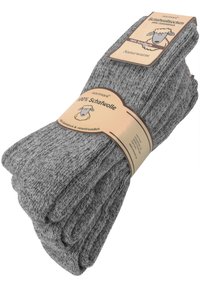 Grahamige Wollsocken gestapelt mit einem braunen Etikett, das 100 % Schafswolle anzeigt. Die Textur ist gestrickt, und das Design ist schlicht mit einem natürlichen Finish.