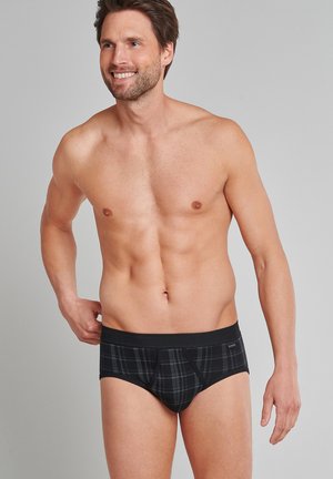Zwarte geruite herenschutters met een zwarte tailleband. Zachte stof met een gladde textuur. Heeft een snug fit en een klassieke snit.