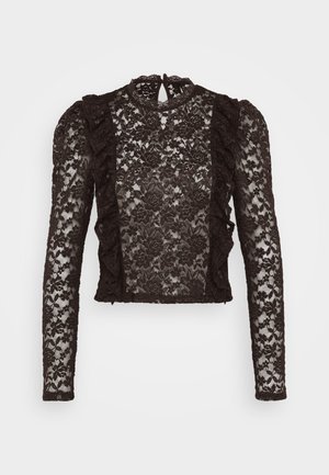 Schwarze Spitzenbluse mit langen Ärmeln, Rüschensaum, stehem Kragen und floralem Muster. Durchsichtiges Design mit filigranen Details.