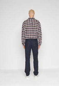 Wrangler GREENSBORO - Straight leg jeans - black