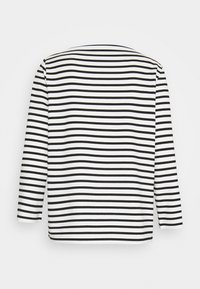 Long-sleeve top in black and white stripes, featuring a round neckline and a relaxed fit with a smooth texture.