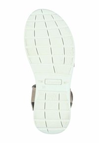 White rubber shoe sole with traction patterns, featuring a textured surface and engraved brand name. Size marked as 38.