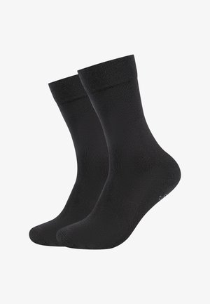 Coppia di calzini neri semplici con polsini a coste, mostrati uno accanto all'altro su uno sfondo bianco.