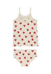 Bombažni dvodelni komplet, ki vključuje kremno barvno majico brez rokavov in ujemajoče se spodnje perilo, oboje okrašeno z vzorcem drobnih rdečih src.