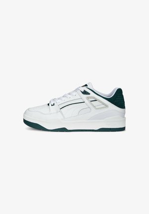 White leather sneakers with green accents, textured back, and a solid rubber sole. Features a lace-up design and side panels with detailing.