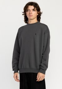 Dark gray sweatshirt made of cotton, featuring a crew neckline, long sleeves, and a small logo on the chest. Simple, relaxed fit.