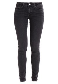 Jeans ajustados negros de mezclilla, con un diseño clásico de cinco bolsillos y una cremallera con un cierre de botón. Textura suave.