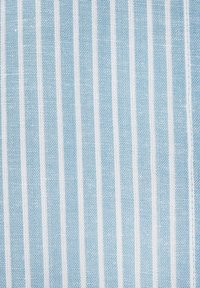 Light blue fabric featuring vertical white stripes, with a textured weave. The stripes are evenly spaced, creating a structured pattern.
