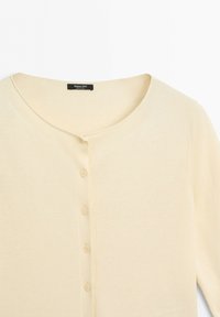 Cream-colored long sleeve cardigan with round neckline and five front buttons, labeled Massimo Dutti.