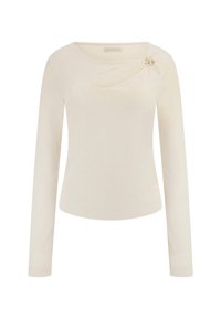 Haut à manches longues crème en côte avec une ouverture en forme de clé près de l'encolure, rehaussé par un bouton décoratif doré sur l'épaule gauche.