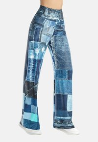 Blue denim-patterned pants with a wide-leg design. Features varying shades of blue, distressed patches, and a smooth, flexible material.