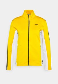 Żółta kurtka na zamek z wysokim kołnierzem, czarnym zamkiem i akcentami bocznymi w białym i czarnym. Zawiera nazwę marki "COLMAR" na klatce piersiowej.