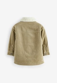 Veste beige en velours côtelé avec col en polaire blanc, manches longues et poignets boutonnés, vue de dos sur fond blanc.