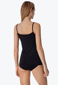 Black ribbed tank top with thin straps and a rounded neckline, paired with matching black bikini briefs, featuring a fitted design.