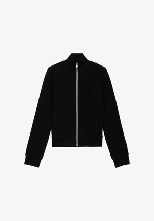 Chaqueta negra con cremallera hecha de un material suave, con cuello alto, mangas largas y dos bolsillos frontales, con un diseño corto.