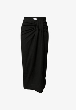 Black knee-length skirt with textured fabric, featuring gathered pleats at the waist and a straight cut. Label on waistband indicates brand.