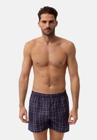 Navy- und hellblaue Karomuster-Boxershorts mit elastischem Bund und einer vorderen Knopfleiste. Der Stoff wirkt leicht und atmungsaktiv.