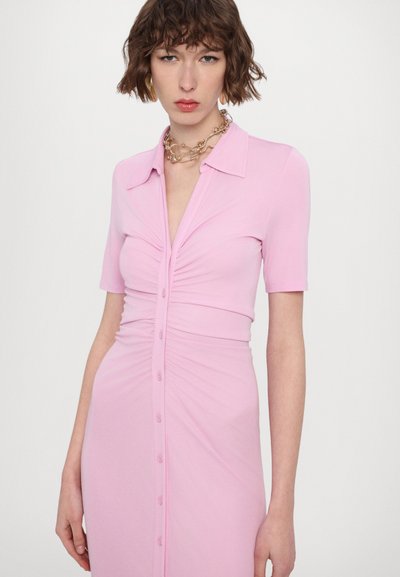 Rosekleurige aansluitende jurk met korte mouwen, ribbeltextuur, knoopsluiting aan de voorkant en geplooide details bij de taille. Minimalistisch kraagontwerp.