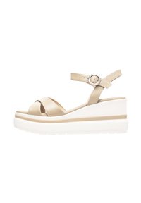 Sandales à talons compensés en cuir beige avec des sangles croisées et une boucle en argent. Elles possèdent une semelle plateforme blanche épaisse avec une surface texturée.