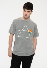 Gray t-shirt made of cotton, featuring a white triangle graphic and a rainbow stripe. Short sleeves, relaxed fit, solid color.