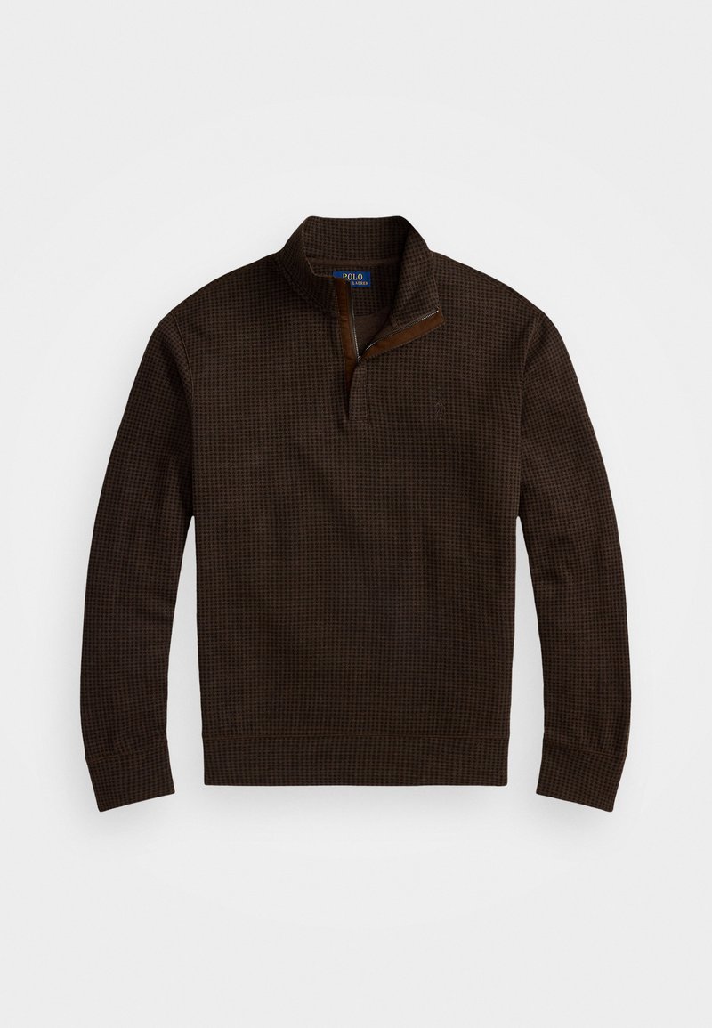 Brun tekstureret pullover sweater med lynlås ved kraven og læderdetalje. Har et diskret gittermønster samt ribstrikkede manchetter og kant.