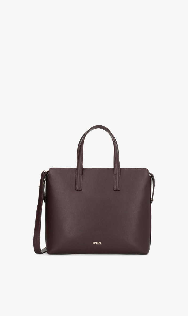 Sac à main en cuir marron foncé avec deux poignées, une bandoulière détachable et un petit logo doré de la marque au centre avant.
