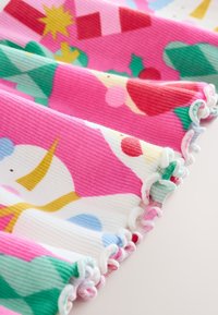 Tela multicolor con patrones en rosa, verde y blanco que presentan lunares y formas geométricas. Material texturizado con costillas y bordes con volantes.