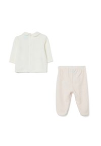 Witte lange mouwen shirt met een ronde kraag en knoopsluiting, gecombineerd met lichtroze gebreide broek met een gestructureerd patroon.