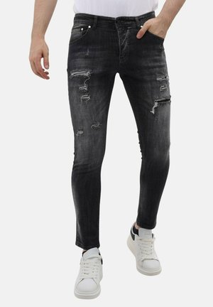 Zwarte slim-fit jeans met versleten patches en rafelige randen, voorzien van een klassieke vijf-pocket ontwerp en een verweerd denim textuur.