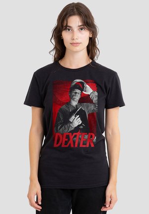 Black t-shirt featuring a graphic design with a man holding a camera against a red background. The word "DEXTER" is prominently displayed below.