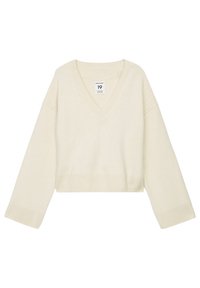 Pull court à col en V en maille douce couleur crème. Comprend des manches larges et un ourlet côtelé. Texture subtile sans motifs ni accents visibles.