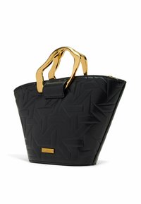 Black handbag made of textured faux leather, featuring a geometric pattern and gold-tone metal handles. Zip closure with a gold brand tag.