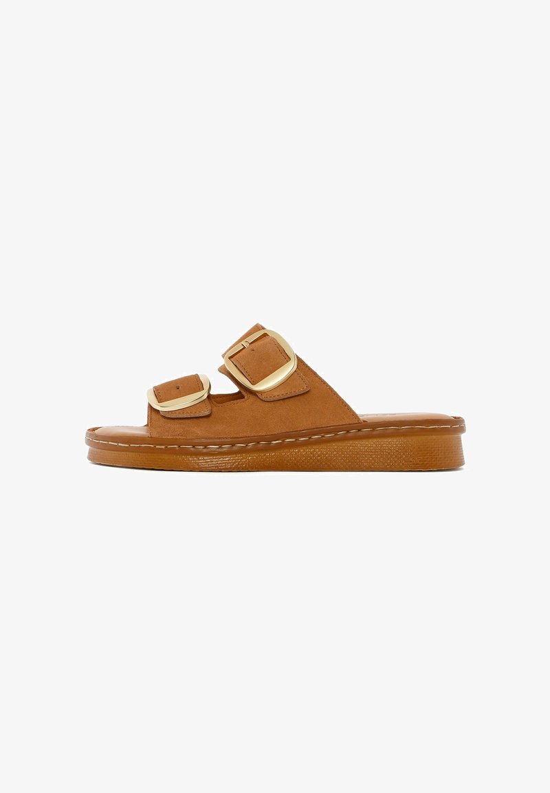 Brown suede slide sandals with two adjustable straps, gold buckles, a textured sole, and a thick flat base for support.