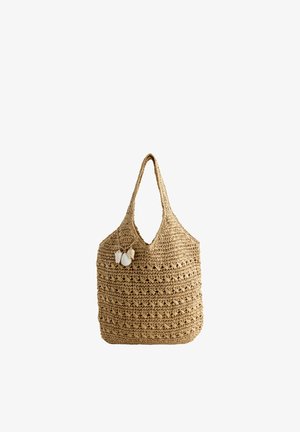 Woven straw tote bag with a shoulder strap, decorated with three hanging seashell charms.