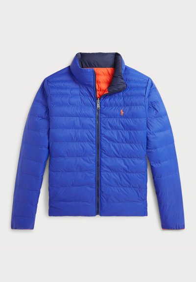 Blue puffer jacket with a zip front, high collar, and orange lining. Features horizontal quilted texture and small logo on the chest.