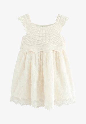 Vestido de bebé blanco sin mangas con corpiño de crochet y falda de tul bordada con flores.