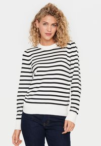 Pull en tricot noir et blanc à rayures, avec un col rond, des poignets et un ourlet côtelés. Texture douce avec des rayures horizontales et une coupe décontractée.
