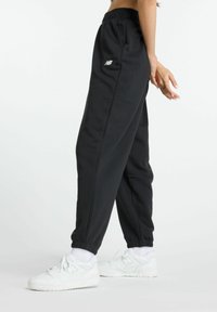New Balance ESSENTIALS FRENCH JOGGER - Tracksuit bottoms - black