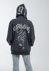 Gray hoodie with a large graphic of a dragon and flowers on the back, featuring the text "Ed Hardy." Hooded with a relaxed fit.