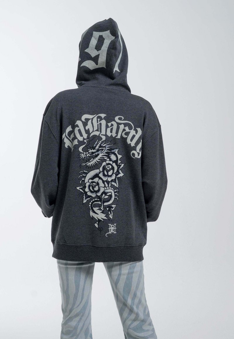 Gray hoodie with a large graphic of a dragon and flowers on the back, featuring the text "Ed Hardy." Hooded with a relaxed fit.