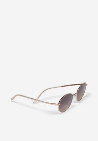 Lunettes de soleil rondes avec une monture en métal rose gold, des verres dégradés gris, des branches fines et un logo discret sur le côté.