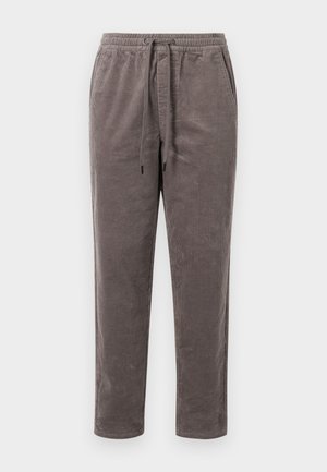 Korduroist püksid tuhmis taupe värvitoonis, millel on elastne vöökoht koos paeltega ja kitsenevad sääred, millel on vertikaalne ribatextuur.