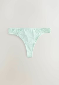 String vert clair pour femme avec des détails floraux en dentelle sur les côtés, posé à plat sur un fond neutre.