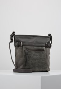 Sac bandoulière en cuir gris avec une finition texturée, doté d'une poche avant zippée et d'une sangle réglable, rehaussé de quincaillerie foncée.