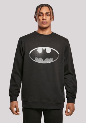Black sweatshirt made of cotton blend, featuring a large, white dotted Batman logo on the front. Classic crew neck and ribbed cuffs.